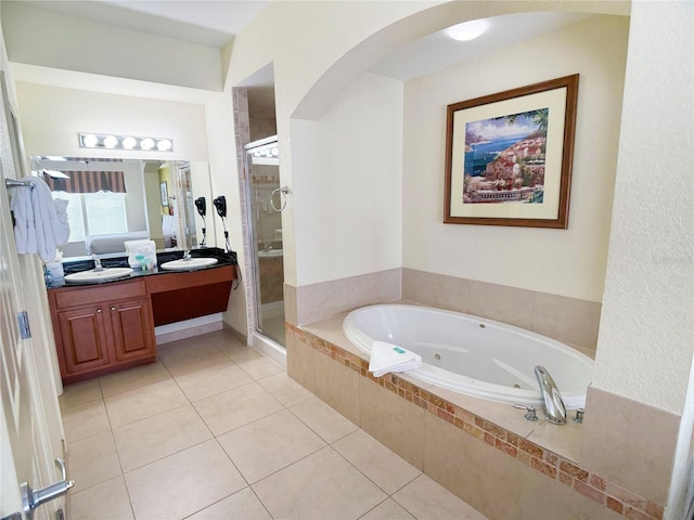 bathroom with tile patterned flooring, vanity, and separate shower and tub