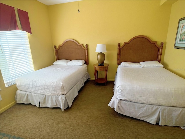 bedroom featuring dark colored carpet