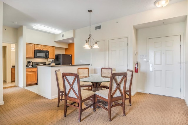 dining area featuring light carpet and an inviting chandelier