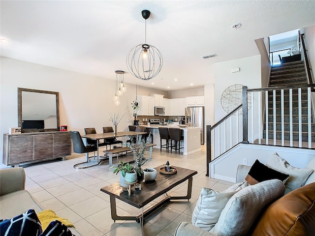 tiled living room featuring an inviting chandelier