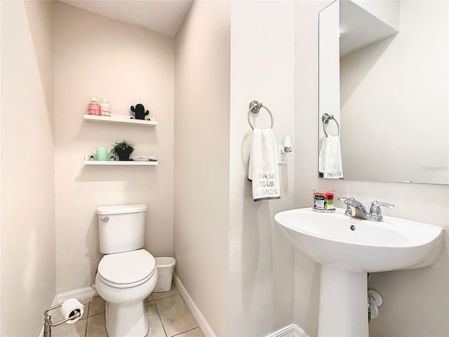 bathroom featuring tile patterned flooring and toilet