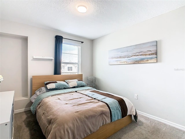 carpeted bedroom with a textured ceiling