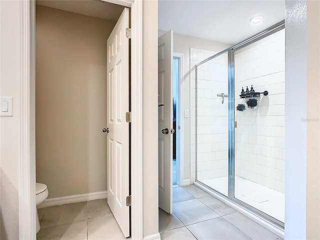 bathroom featuring walk in shower, tile patterned flooring, and toilet