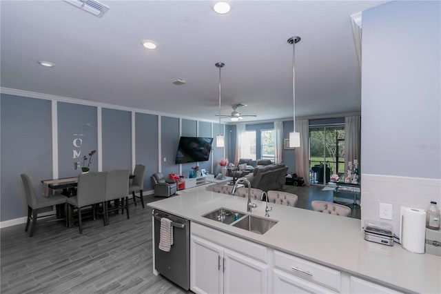 kitchen featuring stainless steel dishwasher, white cabinets, pendant lighting, sink, and ceiling fan