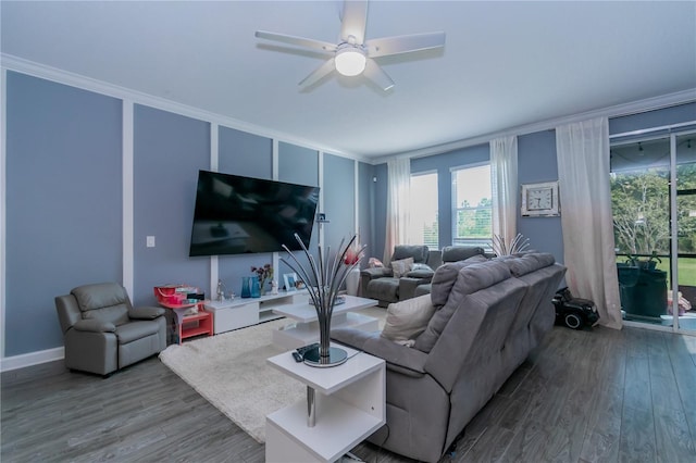 living room featuring ornamental molding, wood-type flooring, and ceiling fan