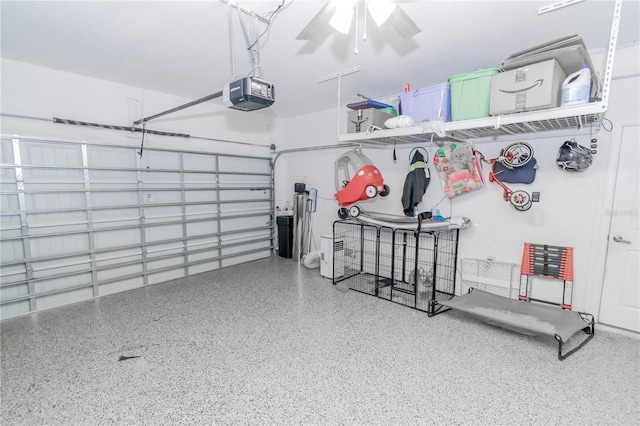 garage featuring a garage door opener and ceiling fan