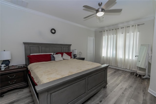 bedroom with hardwood / wood-style floors, ceiling fan, and crown molding