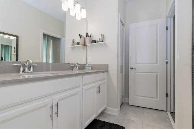 bathroom featuring tile floors, large vanity, and dual sinks