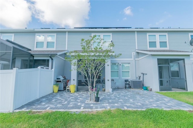 rear view of house featuring a patio area and central AC unit