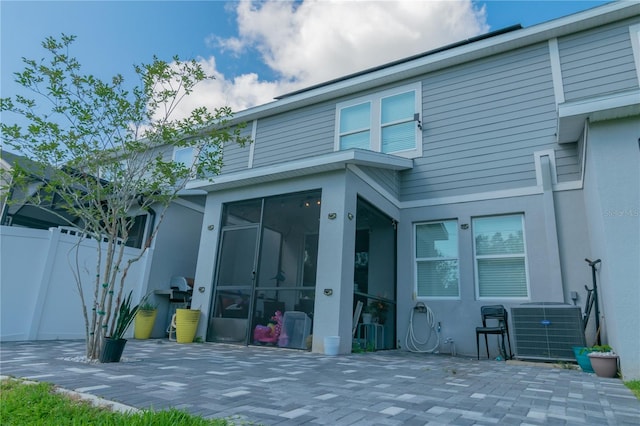 back of property with a patio