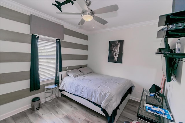 bedroom with ornamental molding, wood-type flooring, and ceiling fan