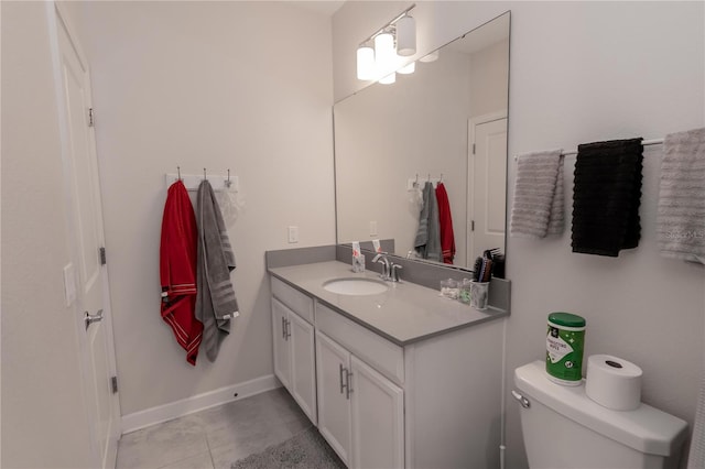 bathroom with tile floors, vanity, and toilet