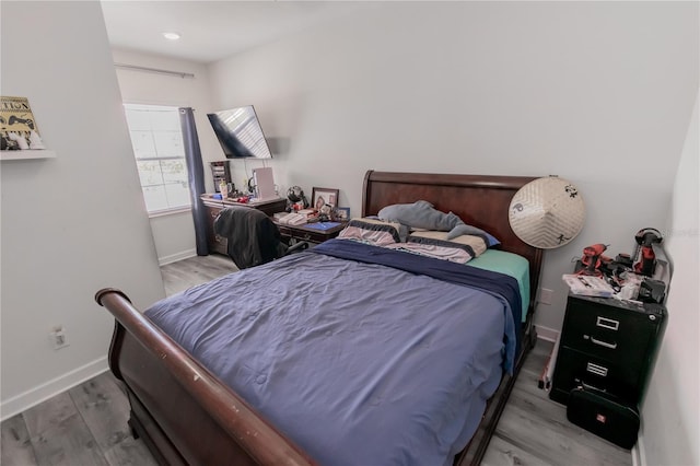 bedroom with hardwood / wood-style floors