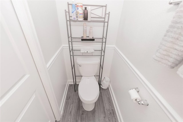 bathroom featuring wood-type flooring and toilet