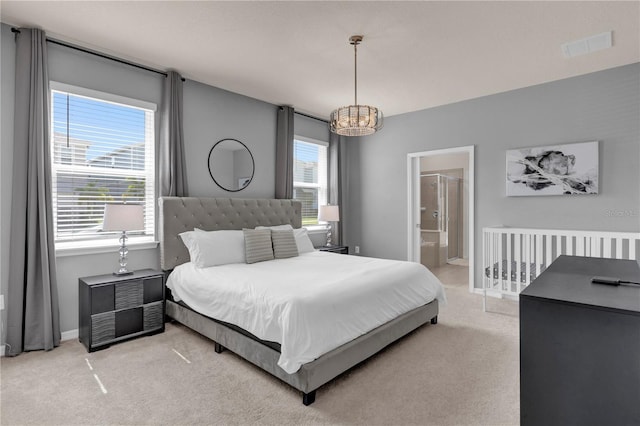 carpeted bedroom with a notable chandelier, multiple windows, and ensuite bath