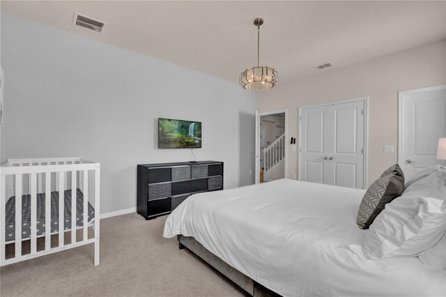 bedroom with carpet floors and a chandelier