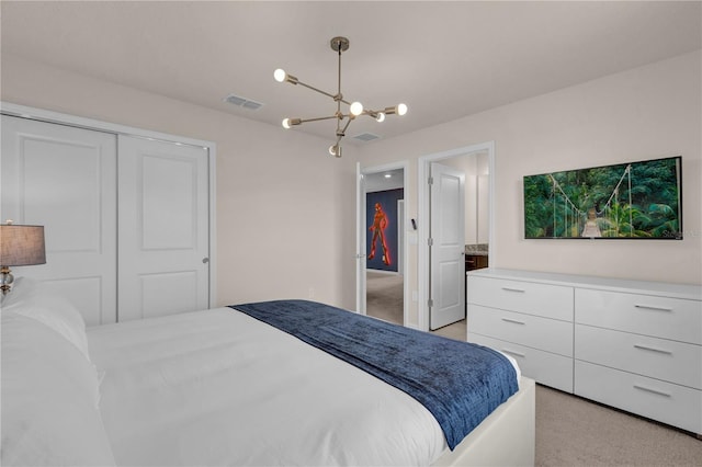 carpeted bedroom with a closet and a notable chandelier