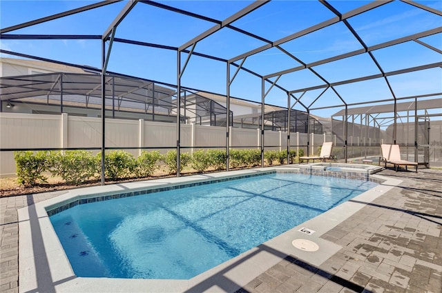 view of pool with a lanai, an in ground hot tub, and a patio