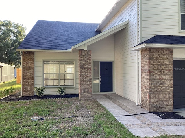 entrance to property featuring a yard