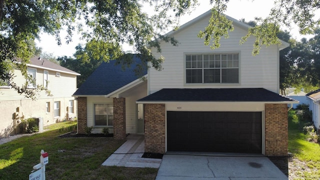 view of front of home featuring a garage and a front lawn