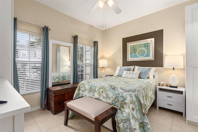 bedroom featuring multiple windows, ceiling fan, and light tile patterned flooring