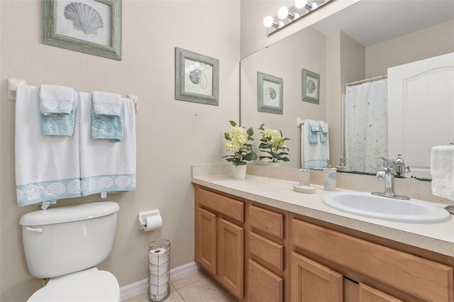 bathroom featuring toilet, vanity, and tile patterned floors