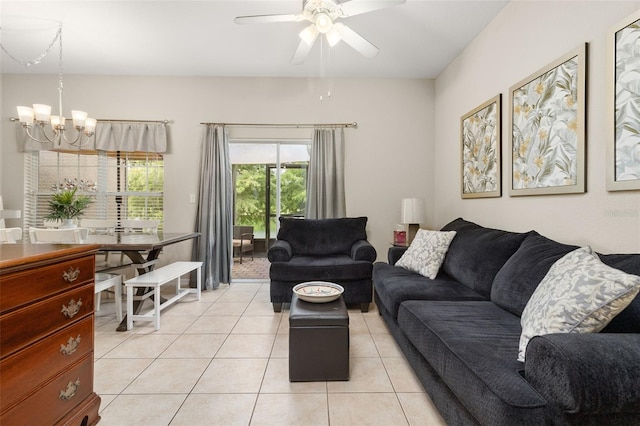 tiled living room featuring ceiling fan with notable chandelier