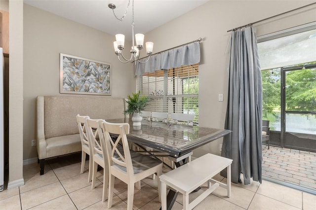 tiled dining space featuring a wealth of natural light and a chandelier