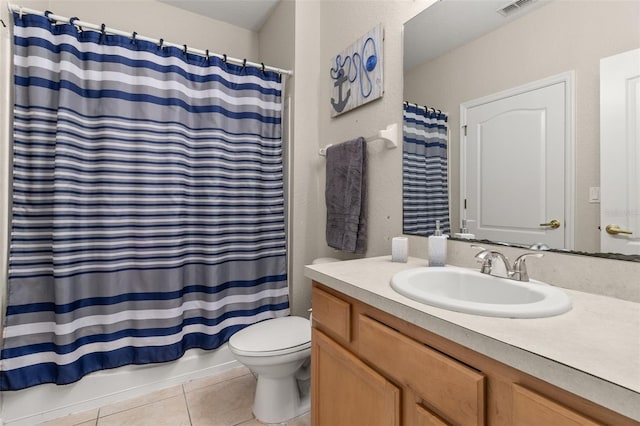 bathroom featuring tile patterned flooring, vanity, and toilet