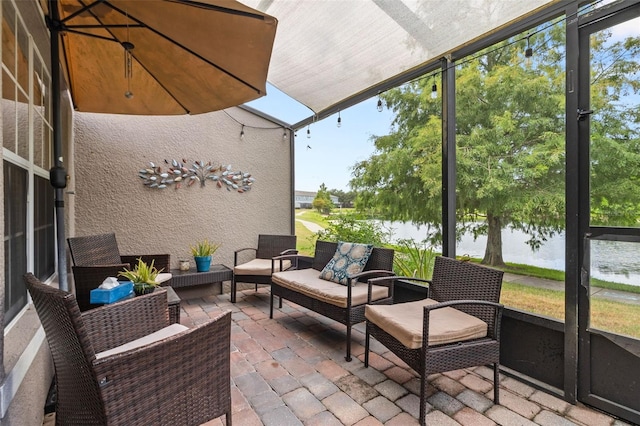 sunroom featuring a healthy amount of sunlight and a water view