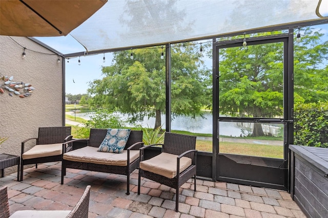 sunroom featuring plenty of natural light and a water view