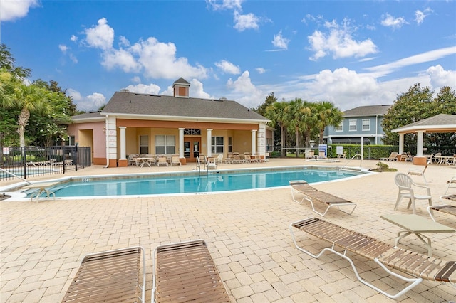 view of swimming pool with a patio and ceiling fan