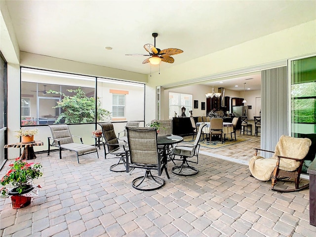 sunroom with ceiling fan