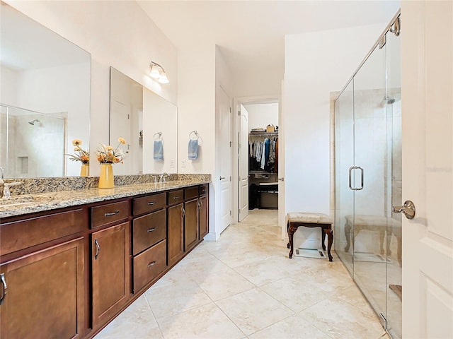 bathroom featuring walk in shower, vanity, and tile patterned flooring