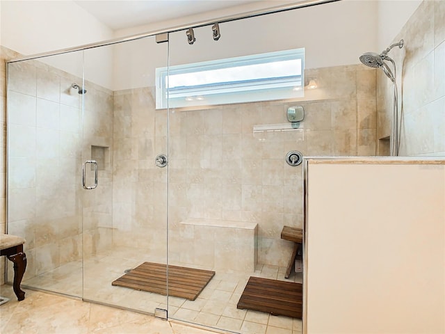 bathroom featuring a shower with door