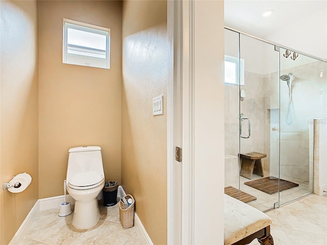 bathroom featuring walk in shower, a healthy amount of sunlight, and toilet