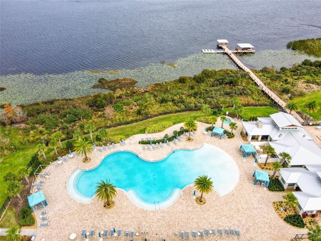 view of pool with a patio and a water view