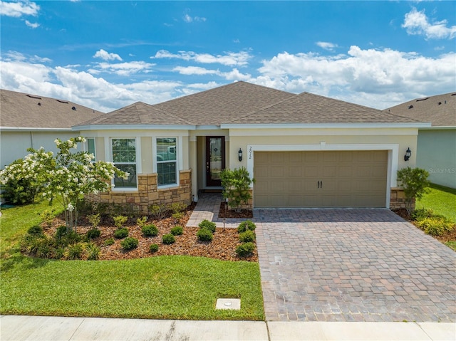 ranch-style house featuring a front yard and a garage