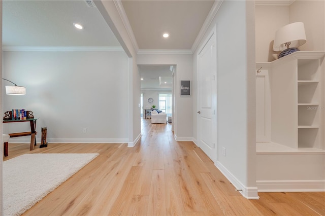 hallway with wood-type flooring and ornamental molding