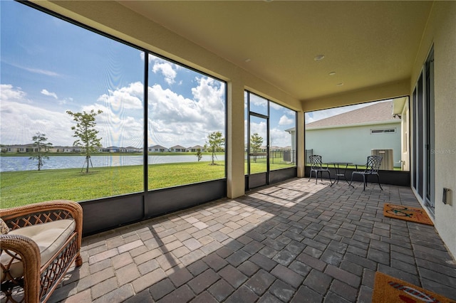 unfurnished sunroom with a water view