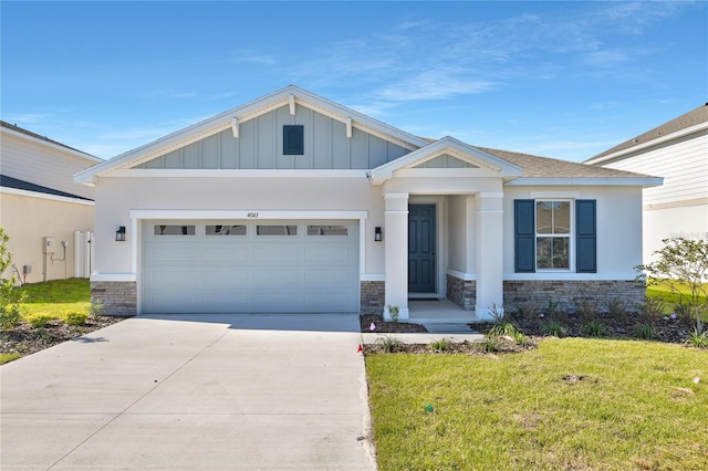 view of front of property with a front yard and a garage