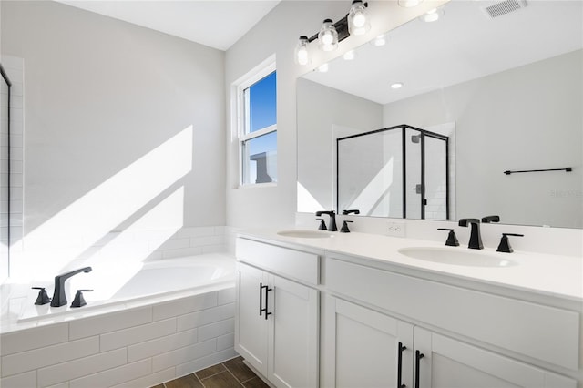 bathroom with vanity and separate shower and tub