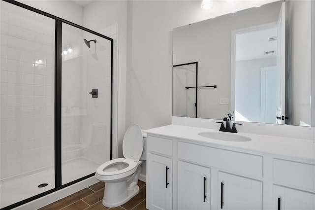 bathroom with an enclosed shower, vanity, and toilet