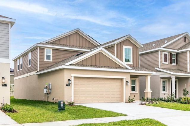 craftsman-style home with a front lawn and a garage