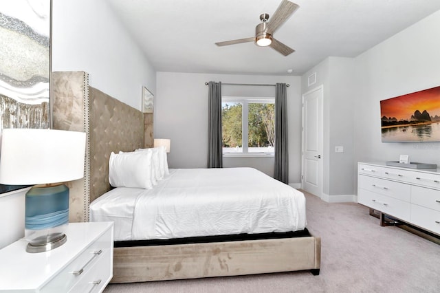 bedroom featuring light colored carpet and ceiling fan