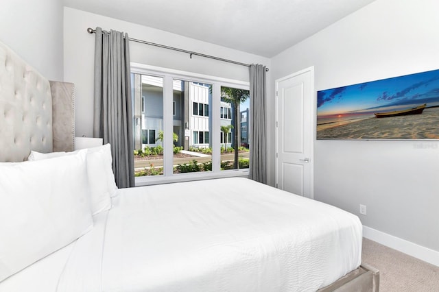 carpeted bedroom featuring multiple windows