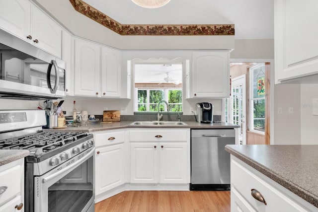 kitchen featuring white cabinetry, sink, and appliances with stainless steel finishes