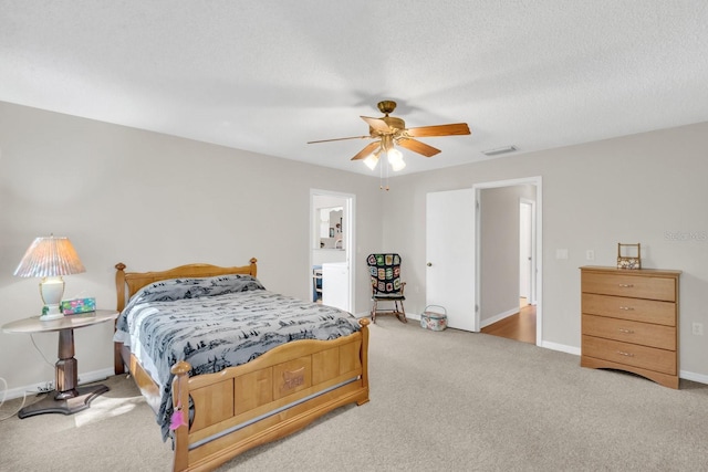 carpeted bedroom with a textured ceiling and ceiling fan