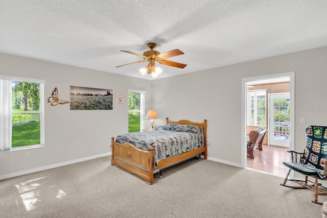 bedroom with carpet flooring, ceiling fan, and multiple windows