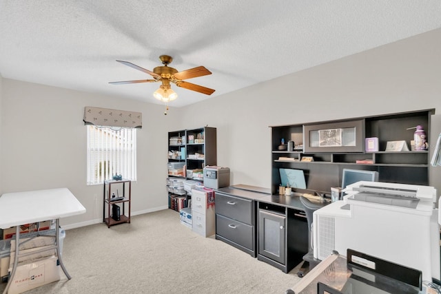 carpeted office with a textured ceiling and ceiling fan